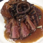 Beef Combination: Wood-Grilled CDK Ranch Strip and Braised Beef Cheeks, Yorkshire Pudding,  Tatsoi, Grilled Red Onions, Horseradish Beef Jus